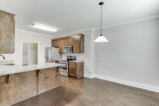 63 Emma Ln, Winder, GA 30680 - kitchen with appliances with stainless steel finishes, ornamental molding, a breakfast bar area, a sink, and dark wood-type flooring