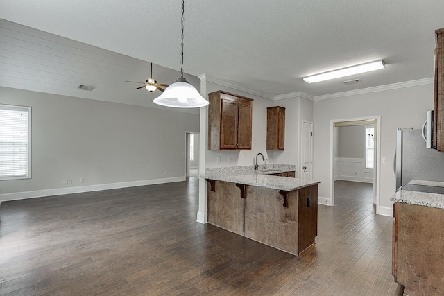 63 Emma Ln, Winder, GA 30680 - kitchen featuring a peninsula, open floor plan, crown molding, appliances with stainless steel finishes, and a sink
