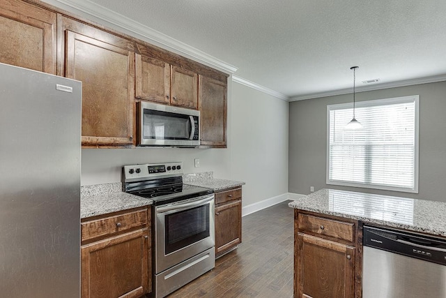 63 Emma Ln, Winder, GA 30680 - kitchen featuring stainless steel appliances, dark wood-style floors, crown molding, pendant lighting, and baseboards