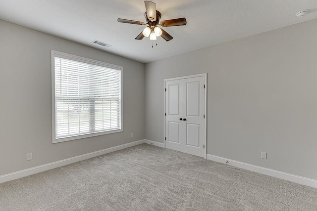 63 Emma Ln, Winder, GA 30680 - unfurnished bedroom featuring baseboards, carpet, a ceiling fan, and a closet