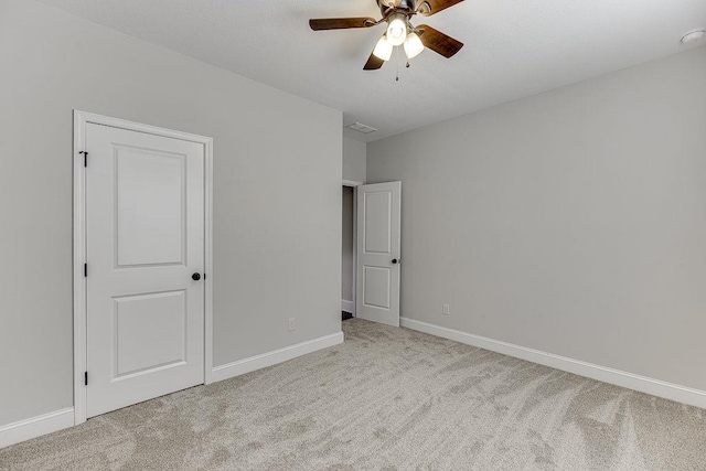 63 Emma Ln, Winder, GA 30680 - unfurnished bedroom with carpet flooring, baseboards, and a ceiling fan
