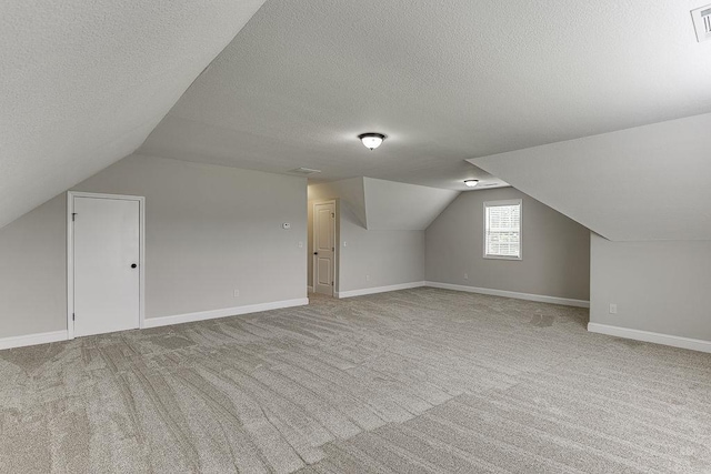 63 Emma Ln, Winder, GA 30680 - additional living space with lofted ceiling, carpet, a textured ceiling, and baseboards