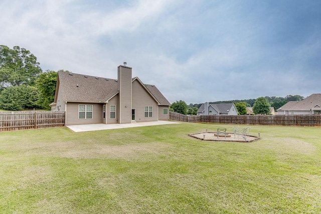 63 Emma Ln, Winder, GA 30680 - back of property with a patio, a fire pit, and a chimney