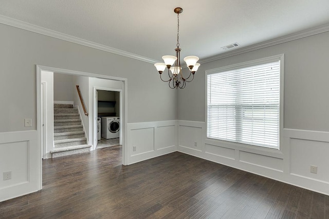 63 Emma Ln, Winder, GA 30680 - spare room featuring washer / clothes dryer, a chandelier, crown molding, a wainscoted wall, and dark wood-type flooring