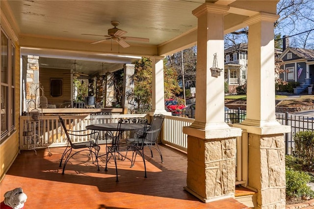 view of patio featuring outdoor dining area and a ceiling fan