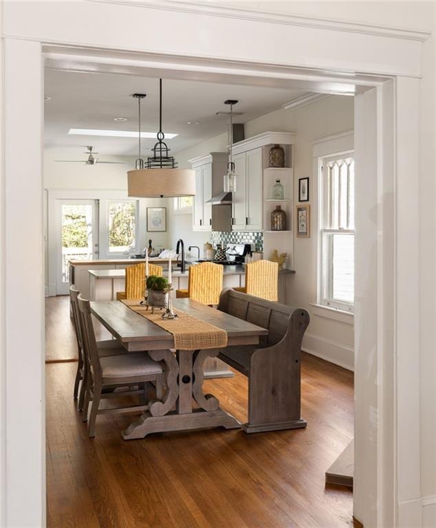 dining area with wood finished floors and baseboards