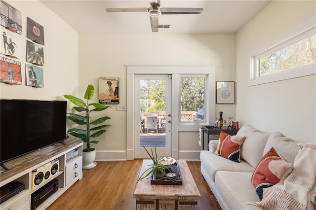 living area featuring ceiling fan, wood finished floors, visible vents, and baseboards