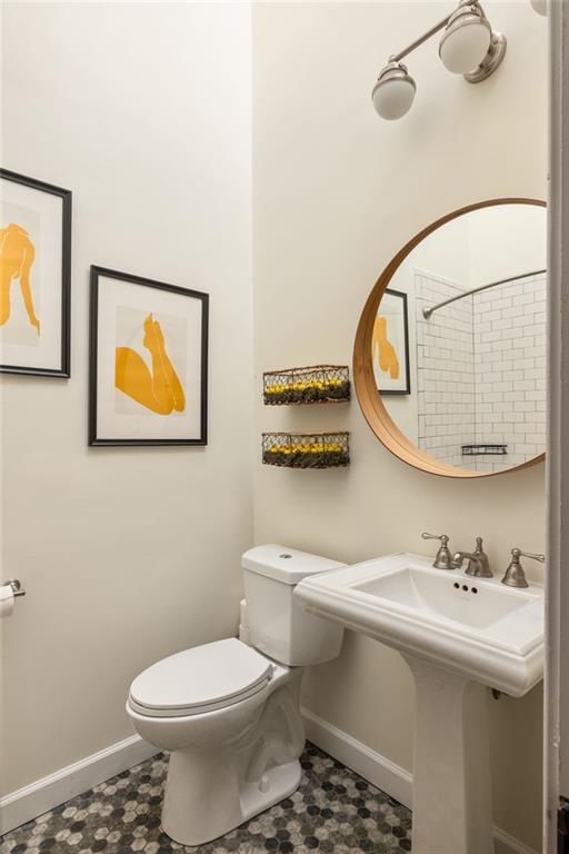 bathroom with toilet and baseboards