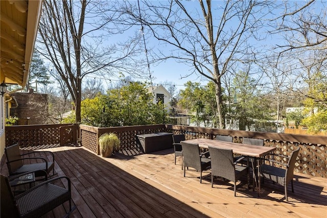 wooden deck featuring outdoor dining area