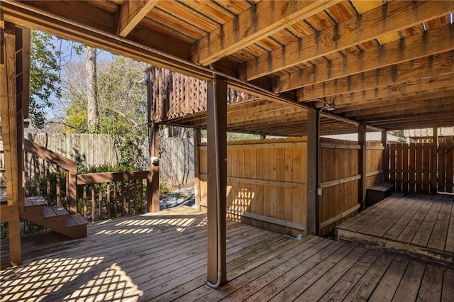 wooden terrace featuring fence