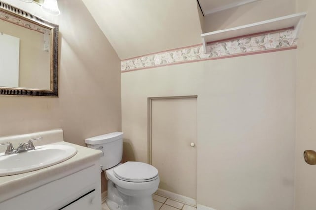 half bath with tile patterned floors, vanity, and toilet