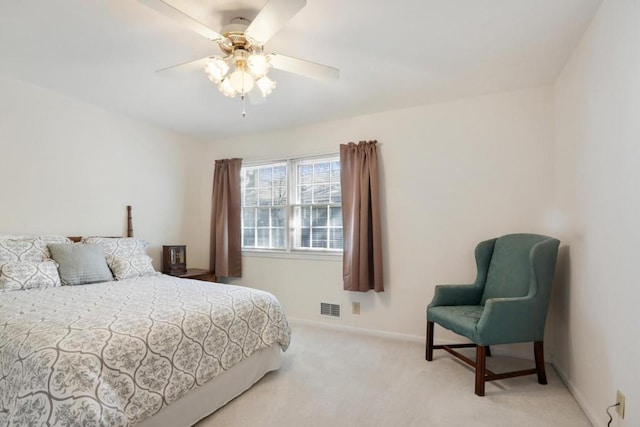 carpeted bedroom featuring baseboards, a ceiling fan, and visible vents