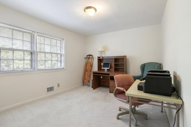 office featuring carpet floors, visible vents, and baseboards