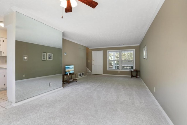 living room with light colored carpet, ornamental molding, a ceiling fan, and visible vents