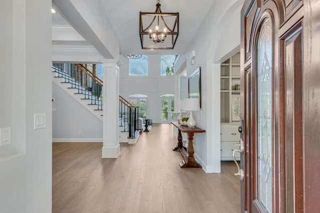 foyer entrance featuring hardwood / wood-style floors and a chandelier