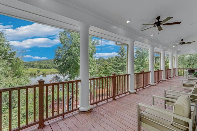 wooden terrace featuring a water view and ceiling fan