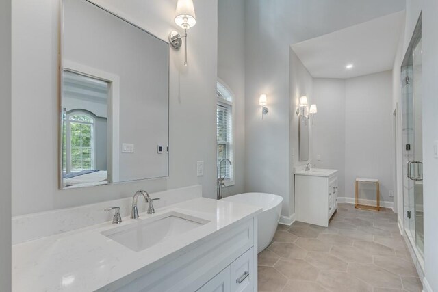 bathroom featuring tile patterned flooring, shower with separate bathtub, and vanity