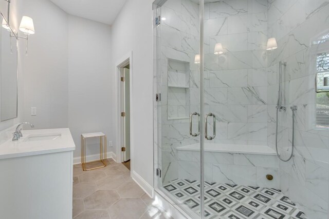 bathroom with tile patterned flooring, walk in shower, and vanity