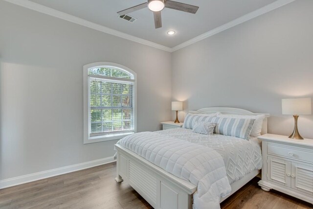 bedroom featuring crown molding, ceiling fan, and dark hardwood / wood-style floors