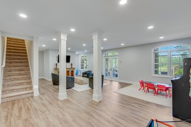 game room featuring light hardwood / wood-style flooring, french doors, and decorative columns