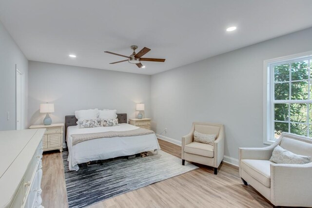 bedroom with light hardwood / wood-style flooring and ceiling fan