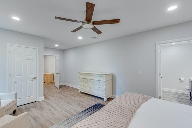 bedroom with ensuite bath, light wood-type flooring, and ceiling fan