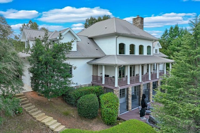 rear view of property with a balcony