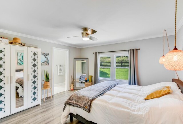 bedroom with crown molding, ceiling fan, and light hardwood / wood-style floors