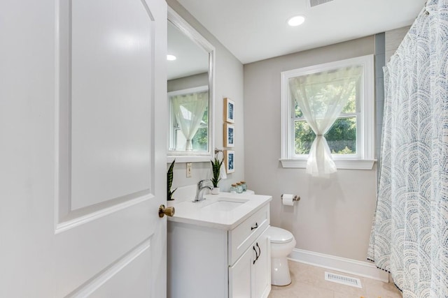 bathroom with tile patterned floors, toilet, curtained shower, and vanity