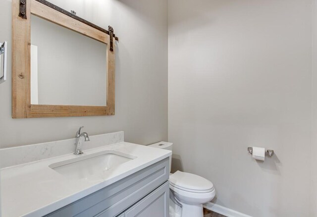 bathroom featuring toilet and vanity