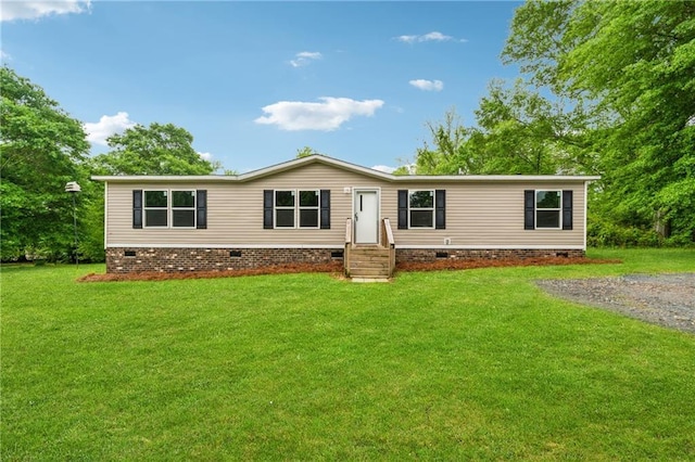 manufactured / mobile home with crawl space, entry steps, and a front yard