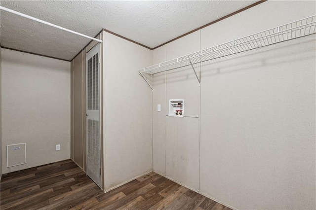 clothes washing area with washer hookup, a textured ceiling, dark wood-style flooring, and laundry area