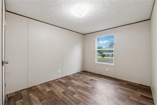 unfurnished room featuring wood finished floors and a textured ceiling