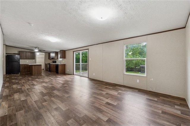 unfurnished living room with a textured ceiling and dark wood-style floors