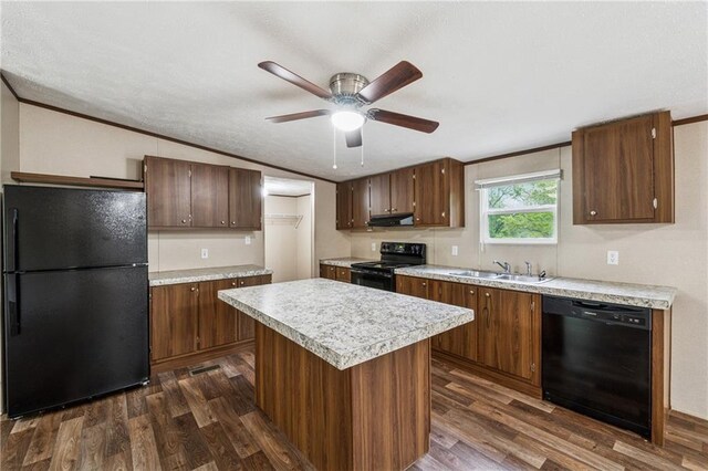 kitchen with light countertops, a sink, dark wood-style flooring, black appliances, and ceiling fan