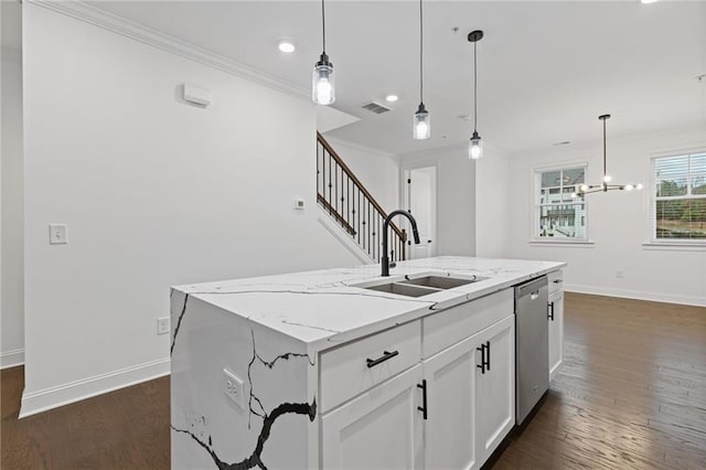 kitchen with decorative light fixtures, white cabinetry, sink, stainless steel dishwasher, and a center island with sink