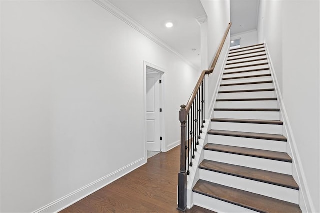 stairs with crown molding and wood-type flooring