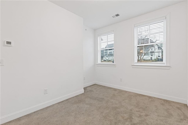 carpeted empty room featuring plenty of natural light