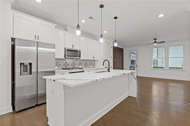 kitchen with ceiling fan, white cabinets, stainless steel appliances, and a kitchen island with sink