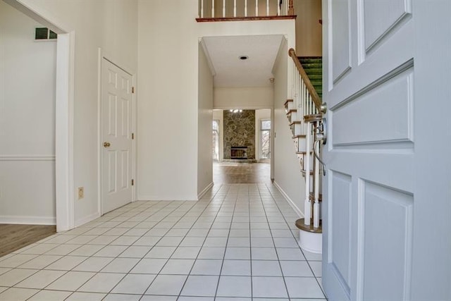 tiled foyer with a fireplace