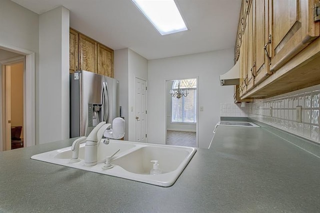 kitchen with stainless steel fridge with ice dispenser and sink