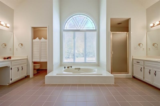 full bathroom featuring independent shower and bath, lofted ceiling, tile patterned flooring, vanity, and toilet