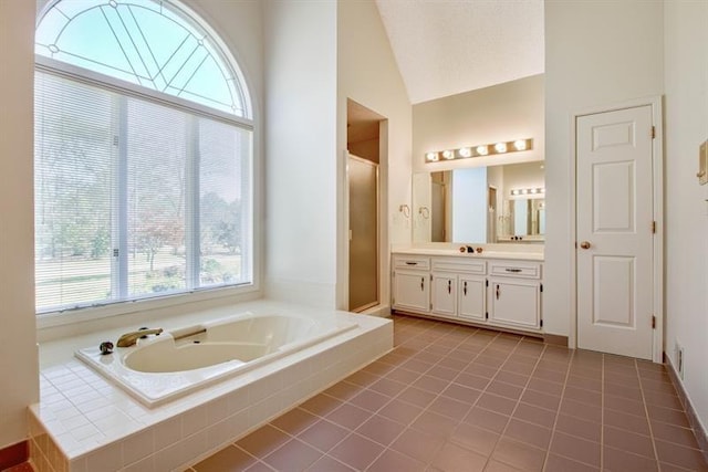 bathroom with tile patterned floors, vanity, shower with separate bathtub, and high vaulted ceiling