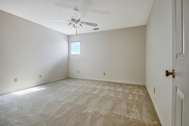 carpeted empty room featuring ceiling fan and a textured ceiling