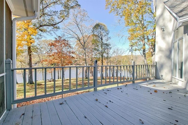 wooden terrace featuring a water view