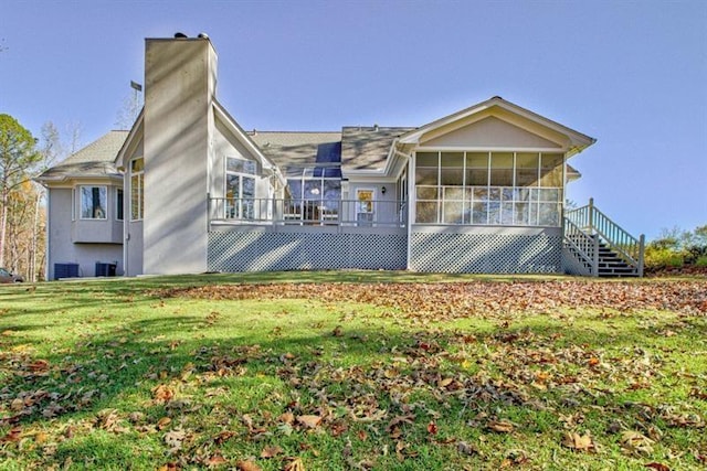 view of front facade with a sunroom and a front yard