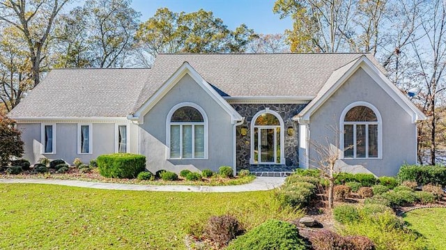 tudor-style house featuring a front yard