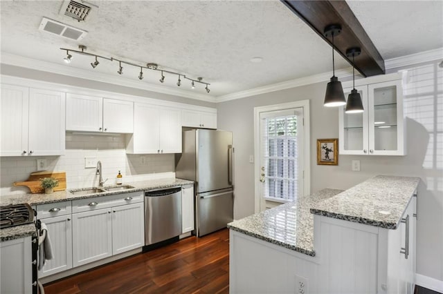 kitchen featuring sink, white cabinetry, stainless steel appliances, dark hardwood / wood-style floors, and crown molding