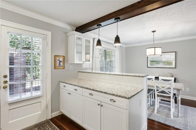 kitchen featuring pendant lighting, crown molding, light stone countertops, dark hardwood / wood-style floors, and white cabinetry