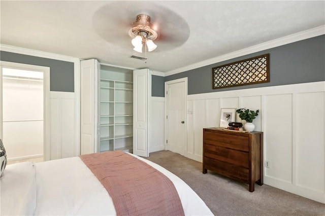 bedroom featuring crown molding, light colored carpet, and ceiling fan